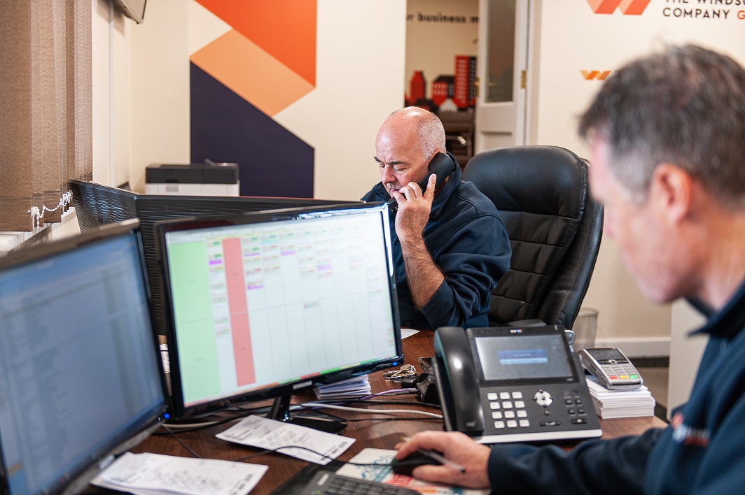 2 members of the TWC staff in the new office