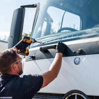 windscreen technician working on lorry